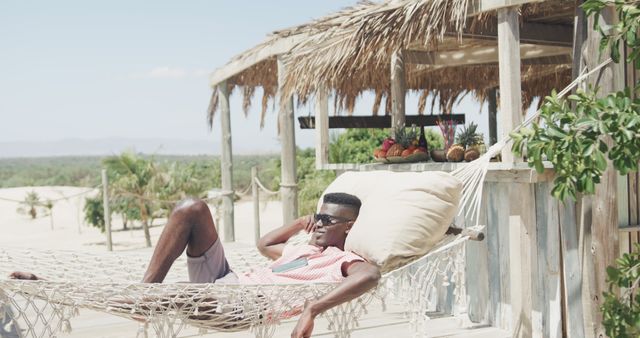 Man Relaxing on Hammock at Tropical Beach Resort Boutique Shed in Summer - Download Free Stock Images Pikwizard.com