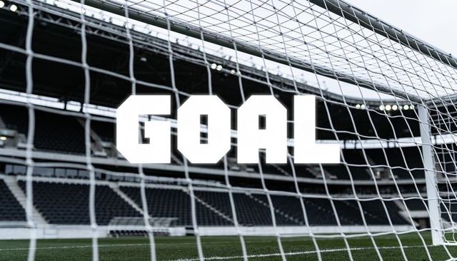 Stadium goal through net with bold goal text, empty stands, overcast lighting
