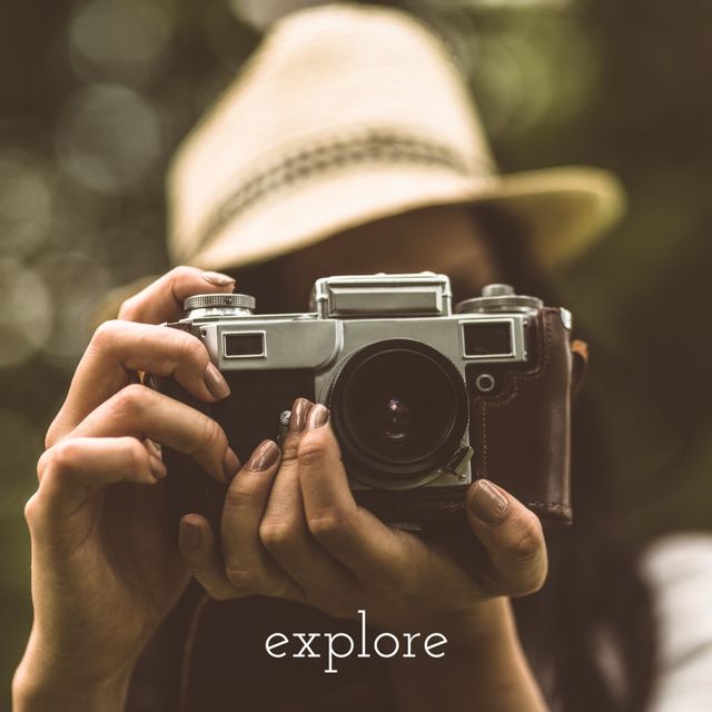 Woman holding vintage camera outdoors, capturing travel moments. Perfect for travel blogs, photography websites, travel magazines, adventure campaigns, and camera retailers. Keywords emphasize travel, photography, equipment, and outdoor exploration.