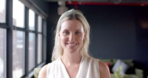 Smiling businesswoman in modern office interior