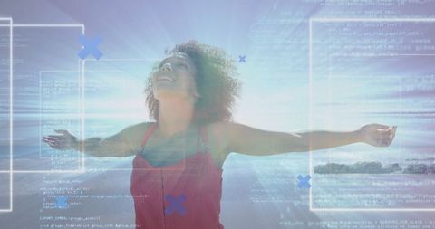 Joyful Woman in Red Dress Embracing Technology Near Ocean
