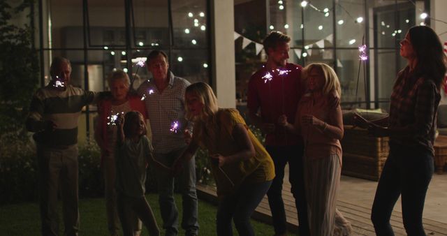 Family Celebrating Outside at Night with Sparklers - Download Free Stock Images Pikwizard.com