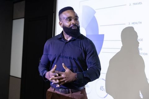 Confident business leader presenting infographic charts at seminar