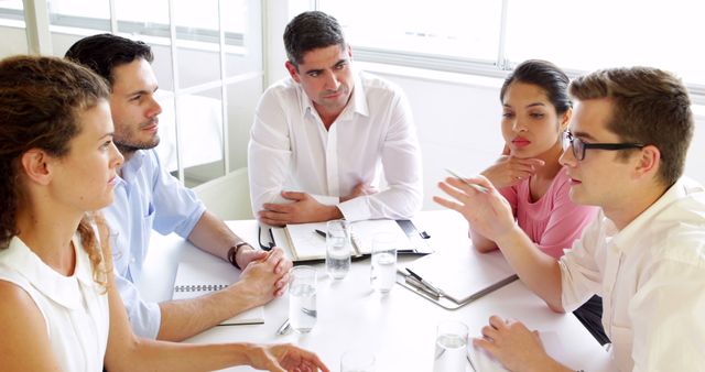 Team Meeting Discussing Business Strategy Around Table - Download Free Stock Images Pikwizard.com