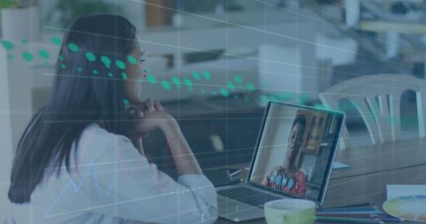 Woman engaging in virtual meeting with financial analysis overlay