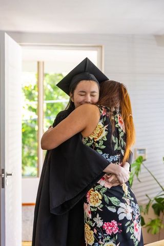 Graduate Hugging Mother at Home Celebration