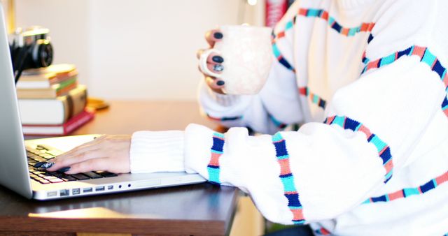 Person Working on Laptop Holding Coffee Mug in Bright Home Office - Download Free Stock Images Pikwizard.com