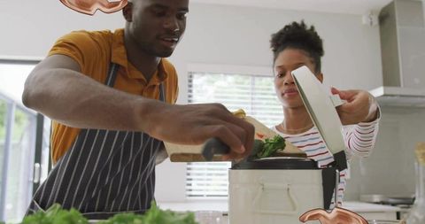 Couple Cooking Together Placing Vegetables in Slow Cooker