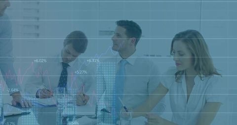 Business Team Analyzing Financial Charts in Modern Office Meeting