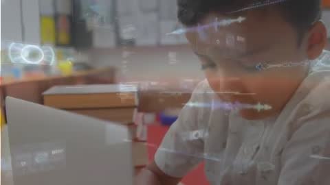 Boy typing on laptop with augmented reality HUD overlays for educational technology video