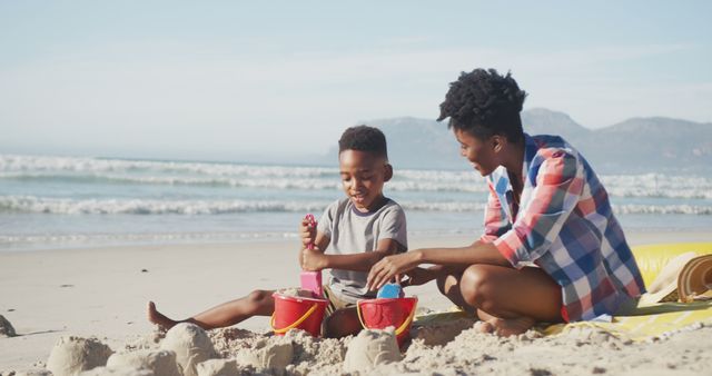 Mother and Son Building Sandcastles on Beach - Download Free Stock Images Pikwizard.com