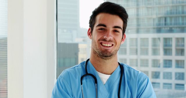 Confident Young Medical Professional Smiling in Hospital Setting - Download Free Stock Images Pikwizard.com