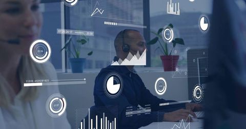Support Agent Typing with Headset and Live Analytics Overlays in Modern Open-Plan Office