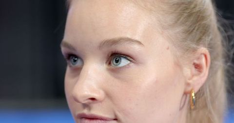 Portrait of Young Woman with Blue-Green Eyes and Gold Hoop Earring
