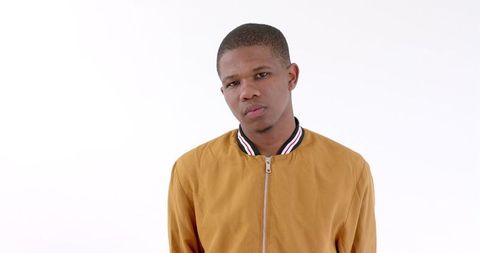 Confident young man in stylish casual jacket isolated against white background