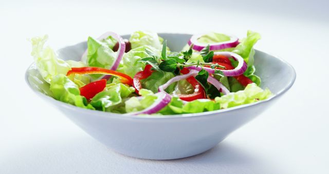 Fresh Vegetable Salad in a White Bowl with Red Onion and Bell Pepper - Download Free Stock Images Pikwizard.com