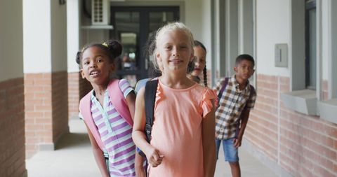 Happy Schoolchildren with Backpacks in Hallway - Download Free Stock Images Pikwizard.com