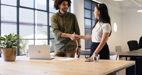 Business Partners Handshaking in Modern Office Setting