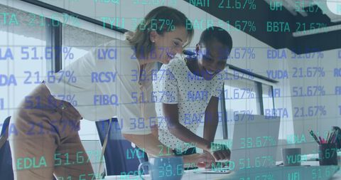 Diverse Businesswomen Analyzing Stock Market Data with Laptops