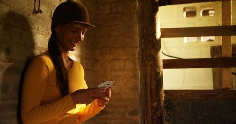 Female construction worker using smartphone at worksite