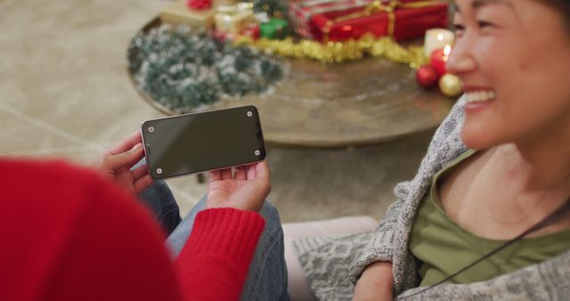 Family Smiling While Looking at Smartphone During Christmas Celebration - Download Free Stock Images Pikwizard.com