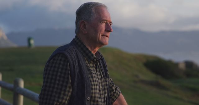 Elderly Man Reflecting Outdoors on Scenic Evening - Download Free Stock Images Pikwizard.com