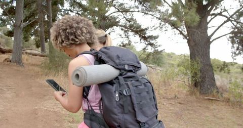 Two Women Hiking with Smartphone in Forest Holding Team Spirit - Download Free Stock Images Pikwizard.com