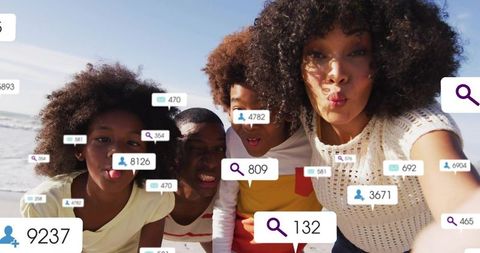 Family taking beach selfie with social media notifications overlay and summer vibes