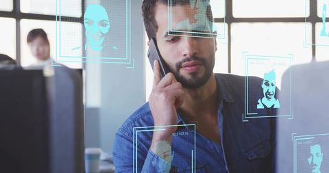Man in office with facial recognition technology overlays