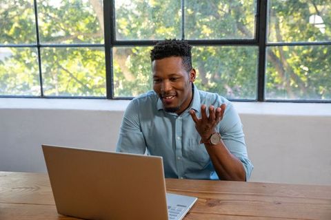 Professional Man Engaging in Video Call with Nature Background