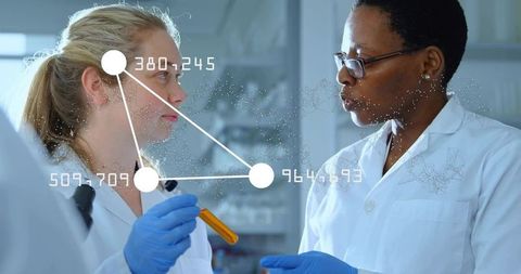 Scientists collaborating in laboratory with digital data overlay holding orange test tube