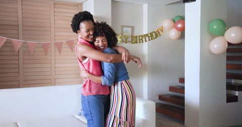 Joyful Birthday Celebration at Home with Diverse Female Couple