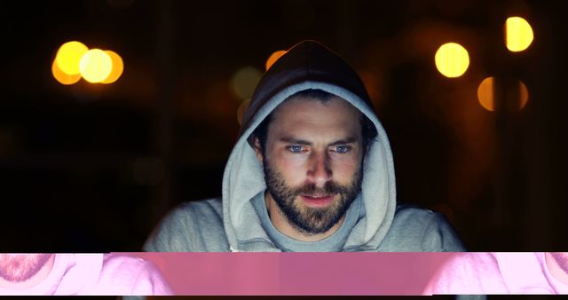 Young Bearded Man in Hoodie Using Laptop at Night Outdoors - Download Free Stock Images Pikwizard.com