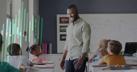 Smiling teacher engaging elementary students in bright modern classroom