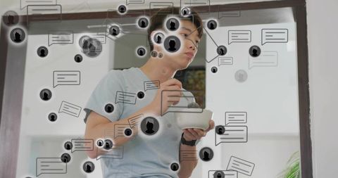 Korean teen eating from bowl while receiving floating chat bubble notifications at doorway