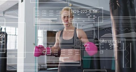 Female boxer training with heavy bag and data overlays — fitness tech concept
