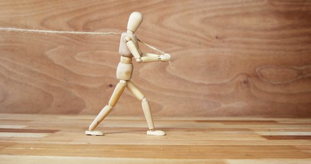 Wooden Mannequin Pulling Rope on Wooden Background - Download Free Stock Images Pikwizard.com