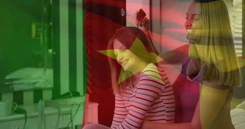 Cameroon Flag Overlay on Mother Brushing Daughter's Hair