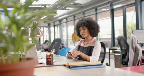 Business Woman Using Smartphone in Modern Office