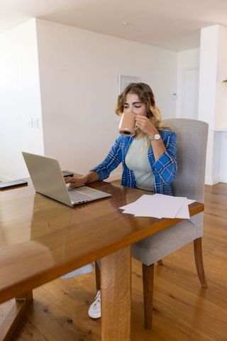 Woman balancing relaxation and productivity in home workspace