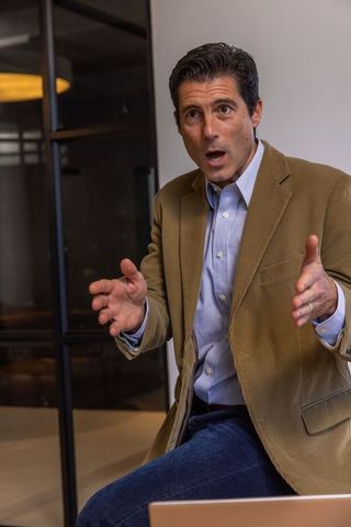 Male executive gesturing during office meeting