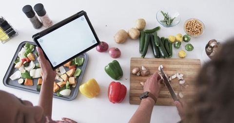 Diverse Friends Cooking Together with Tablet and Fresh Vegetables