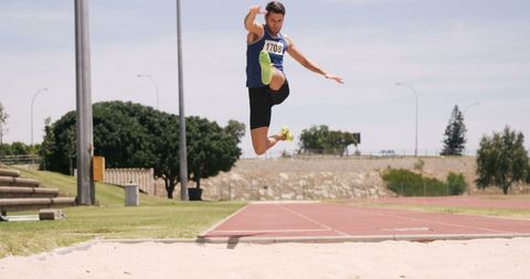 Athlete Performing Long Jump Outdoors in Sandpit - Download Free Stock Images Pikwizard.com