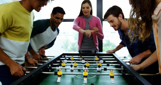 Young Colleagues Enjoying Office Foosball Game Break - Download Free Stock Images Pikwizard.com