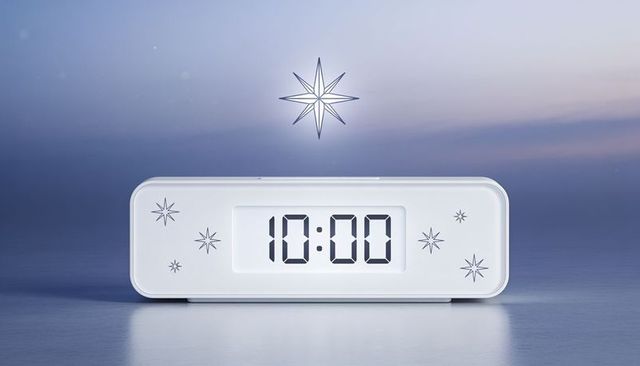 Displaying white rounded digital alarm clock with 10:00 led display and starburst accents