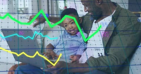 Father Son Duo Learning Financial Data on Laptop at Home