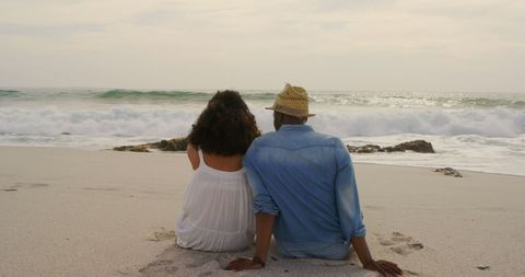 Romantic Couple Relaxing on Sandy Beach at Sunset - Download Free Stock Images Pikwizard.com