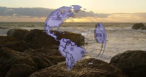 Holographic globe overlay hovering above rocky shoreline at sunset