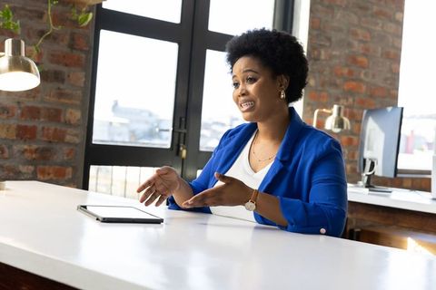 Confident businesswoman engaging in office discussion