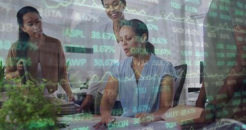 Diverse Businesswomen Collaborating in Modern Office with Financial Data Overlay